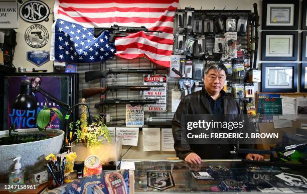 Gun shop owner David Liu poses at the counter of his store in Arcadia, California, on February 10, 2023. 6 percent of the US population identifies as...