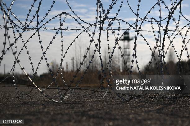 Ukrainian observation tower is pictured behind barbed wire fencing as seen from the Divin border crossing point between Belarus and Ukraine in the...