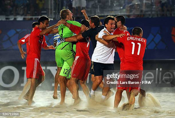 Head coach Mikhail Likhachev of Russia celebrates with his players after winning the FIFA Beach Soccer World Cup Final between Russia and Brazil at...