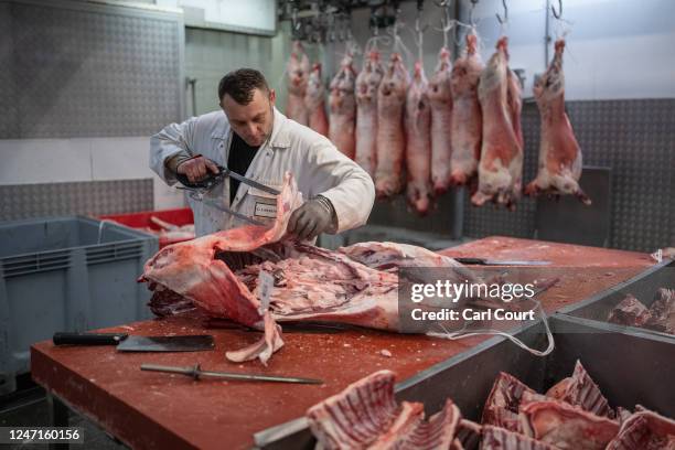 Butcher prepares meat at Smithfield Market on February 15, 2023 in London, England. Central London's Smithfield meat market, which dates from the...