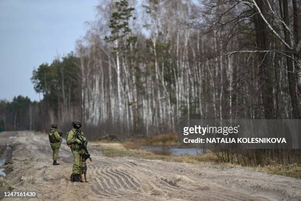 Belarusian border guards patrol along the frontier near the Divin border crossing point between Belarus and Ukraine in the Brest region on February...