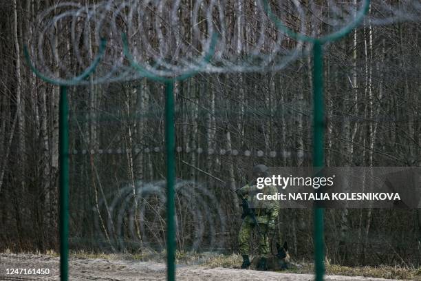 Belarusian border guards patrol along the frontier near the Divin border crossing point between Belarus and Ukraine in the Brest region on February...