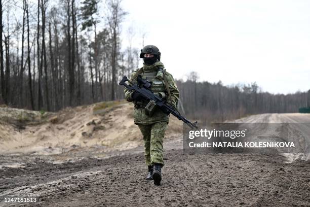 Belarusian border guards patrol along the frontier near the Divin border crossing point between Belarus and Ukraine in the Brest region on February...