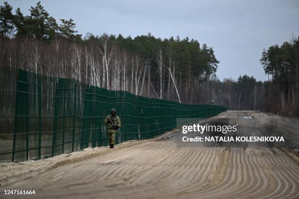 Belarusian border guards patrol along the frontier near the Divin border crossing point between Belarus and Ukraine in the Brest region on February...