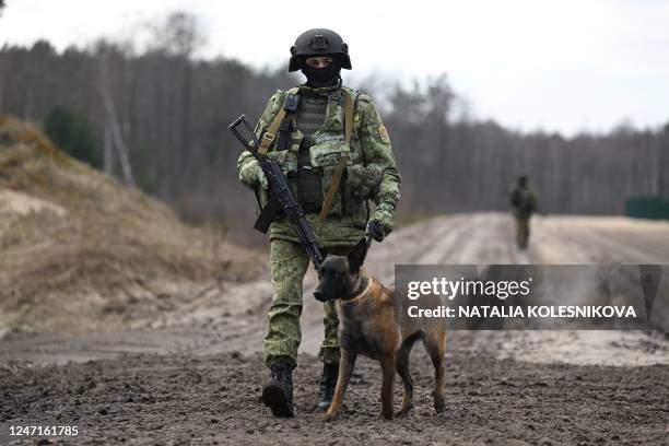 Belarusian border guards patrol along the frontier near the Divin border crossing point between Belarus and Ukraine in the Brest region on February...