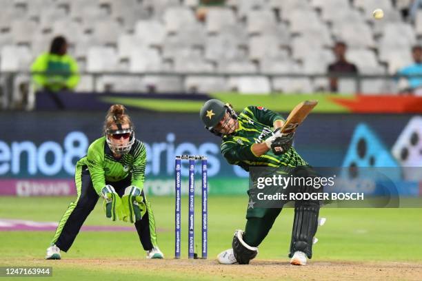 Pakistan's Ayesha Naseem hits a six as Ireland's wicketkeeper Mary Waldron reacts during the Group B T20 women's World Cup cricket match between...