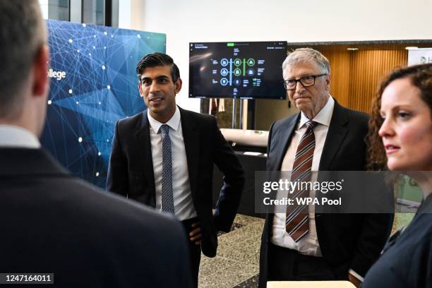 Britain's Prime Minister Rishi Sunak and Microsoft founder Bill Gates speak with members of Econic a startup developing technologies that enable the...