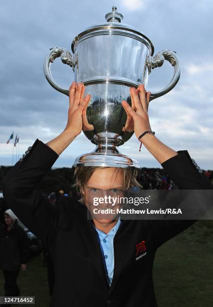 Tom Lewis of Great Britain and Ireland celebrates with the Wlaker Cup after defeating the United States of America during the day two afternoon...