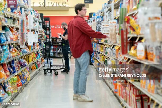 Shoppers look at items displayed at a grocery store in Washington, DC, on February 15, 2023. - Retail sales in the United States rebounded in...