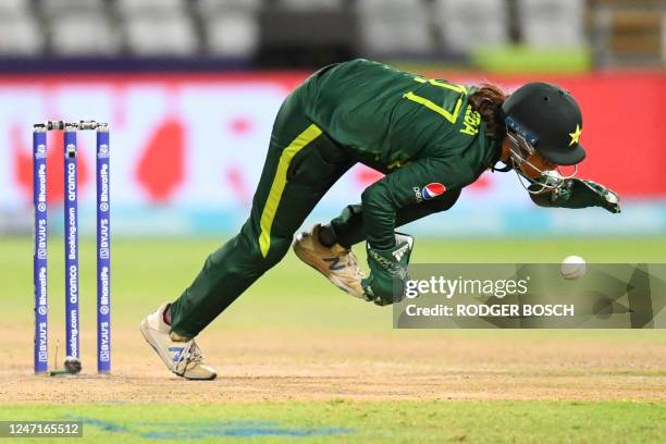 Pakistan's wicketkeeper Muneeba Ali dives while fielding during the Group B T20 women's World Cup cricket match between Pakistan and Ireland at...