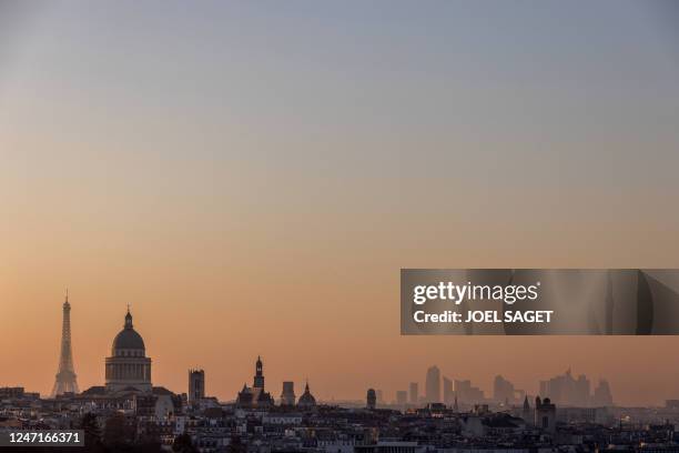 This photograph taken on February 13, 2023 shows a skyline of Paris with the Eiffel tower , the Pantheon , business district of La Defense and Arc de...