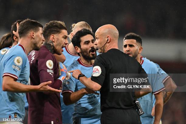 Manchester City players argue with referee as he gives a penalty kick to Arsenal during the English Premier League football match between Arsenal and...