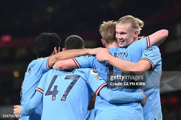 Manchester City's Norwegian striker Erling Haaland celebrates with teammates after scoring his team third goal during the English Premier League...