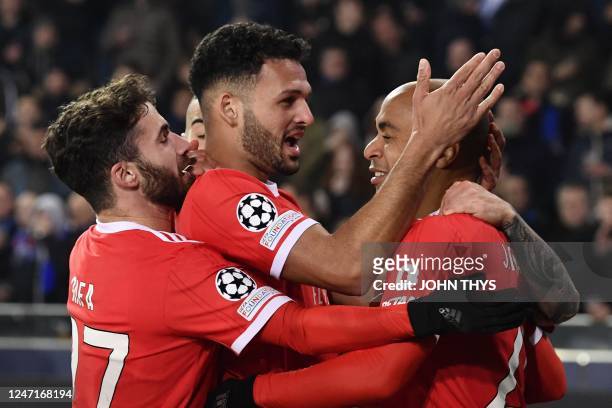 Benfica's Portuguese midfielder Joao Mario celebrates with teammates after scoring a goal during the UEFA Champions League round of sixteen first leg...
