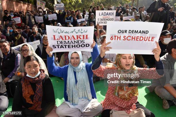 Protestors hold placards during a protest demanding statehood for the Ladakh region on February 15, 2023 in New Delhi, India. Ladakh was separated...