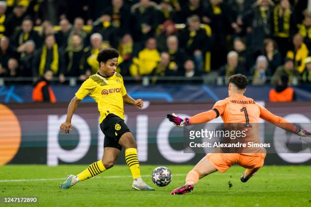 Karim Adeyemi of Borussia Dortmund is scoring a goal during the UEFA Champions League round of 16 leg one match between Borussia Dortmund and Chelsea...