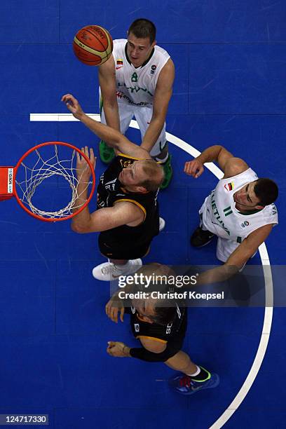 Paulius Jankunas of Lithuania, Chris Kaman of Germany, Jonas Valanciunasof Lithuania and Sven Schultze of Germany fight for the ball during the...