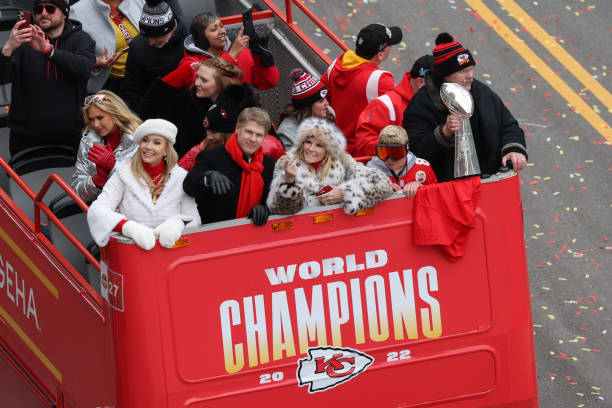 Chiefs owner Clark Hunt, wife Tavia, mother Norma, daughter Gracie and head coach Andy Reid hold the the Lombardi trophy during the Chiefs Super Bowl...
