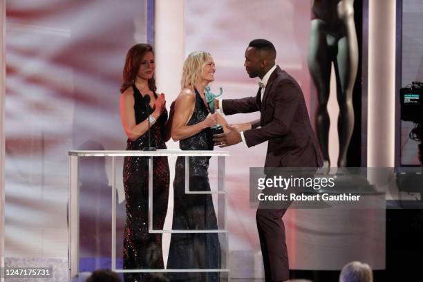 January 27, 2019- Mahershala Ali hugs Robin Wright as he accepts Outstanding Performance by a Male Actor in a Supporting Role for ?"Green Book"...