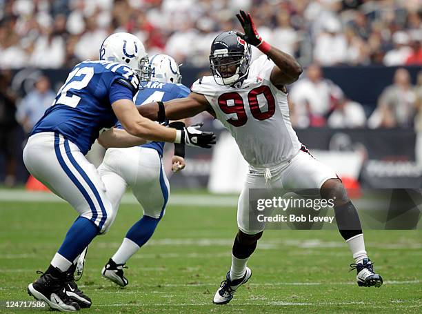 Mario Williams of the Houston Texans battles with offensive tackle Jeff Linkenbach of the Indianapolis Colts during the season-opening game at...