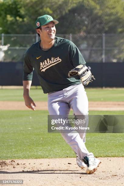 Major League Baseball rookie Shintaro Fujinami participates in drills during the Oakland Athletics' first day of spring training workouts in Mesa,...