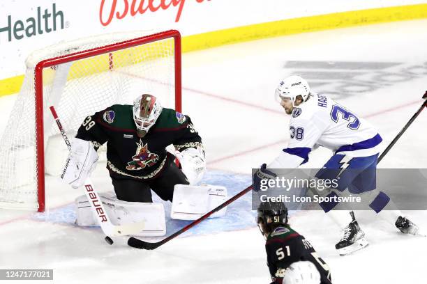 Arizona Coyotes goaltender Connor Ingram makes a save against Tampa Bay Lightning left wing Brandon Hagel during the first period of a Hockey game...