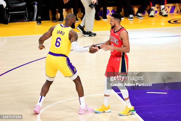 LeBron James of the Los Angeles Lakers and CJ McCollum of the New Orleans Pelicans high fives during the game between the New Orleans Pelicans and...