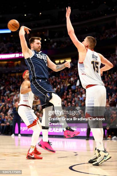 Luka Doncic of the Dallas Mavericks makes a no-look pass against Nikola Jokic of the Denver Nuggets at Ball Arena on February 15, 2023 in Denver,...