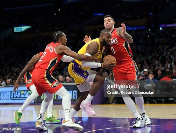 LeBron James of the Los Angeles Lakers is fouled by Josh Richardson of the New Orleans Pelicans as Willy Hernangomez of the Pelicans defends in the...
