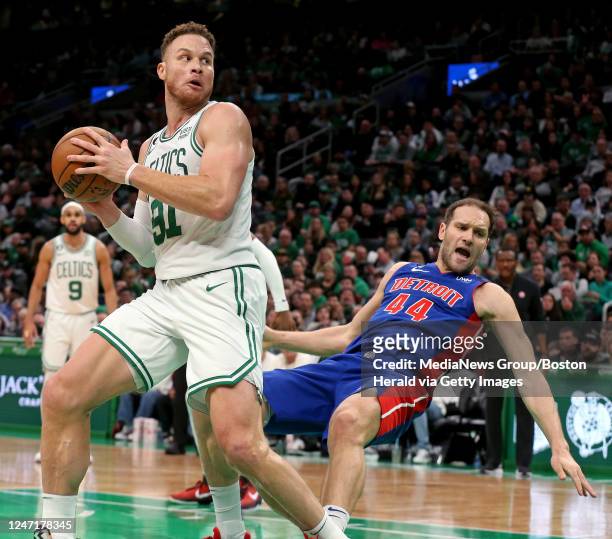 February 15: Blake Griffin of the Boston Celtics fouls Bojan Bogdanovic of the Detroit Pistons during the first half of the NBA game at the TD Garden...