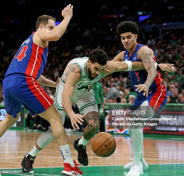 February 15: Jayson Tatum of the Boston Celtics gets through Bojan Bogdanovic and Killian Hayes of the Detroit Pistons during the first half of the...