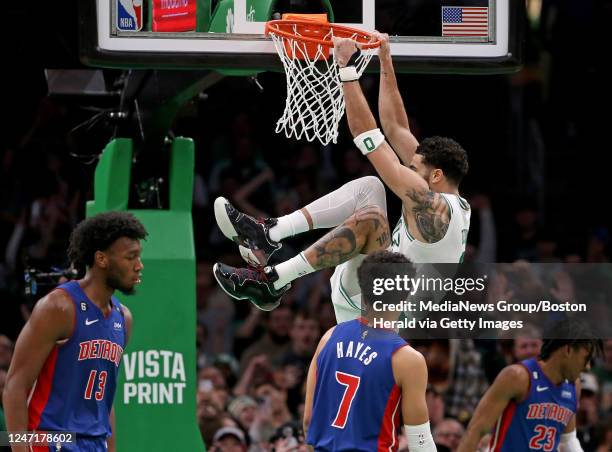 February 15: Jayson Tatum of the Boston Celtics hangs on the rim after dunking during the second half of the NBA game against the Detroit Pistons at...