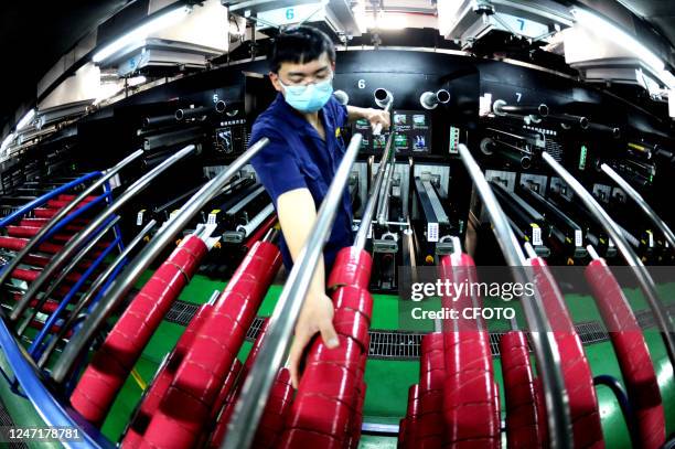 Worker makes spandex at a production line in Lianyungang, East China's Jiangsu province, Feb 16, 2023.