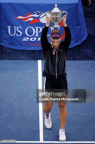 Samantha Stosur of Australia celebrates with the championship trophy after defeating Serena Williams of the United States to win the Women's Singles...