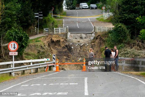 This photo shows the remains of the Puketapu Bridge that washed away during Cyclone Gabrielle near Napier on February 16, 2023. - New Zealand is...