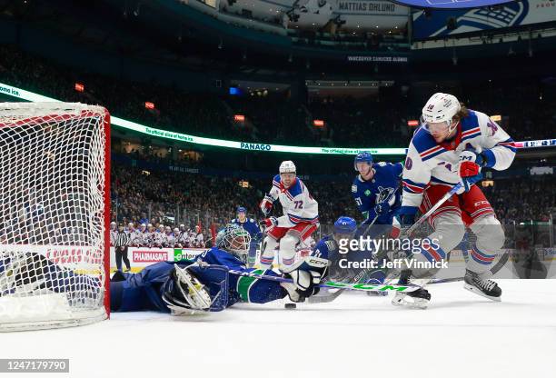 Arturs Silovs of the Vancouver Canucks makes a save on Artemi Panarin of the New York Rangers shot during the first period of their NHL game at...