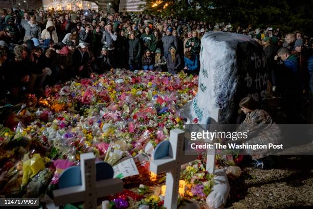 February 15: People gather at the memorial during the vigil at The Rock on Michigan State Universitys campus in East Lansing, Michigan on February...