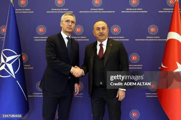 Turkish Foreign Minister Mevlut Cavusoglu shakes hands with NATO Secretary General Jens Stoltenberg during a meeting in Ankara, on February 16, 2023.