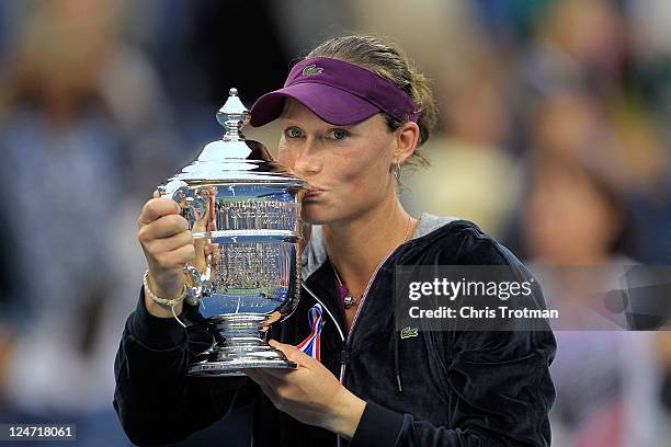 Samantha Stosur of Australia celebrates with the championship trophy after defeating Serena Williams of the United States to win the Women's Singles...