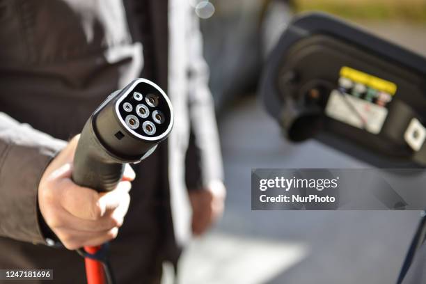 Man charging his electric car is seen in L'Aquila, Italy, on February 16, 2023. European Union confirmed the stop to new gasoline and gasol car sale...