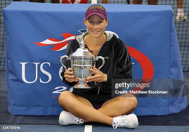 Samantha Stosur of Australia celebrates with the championship trophy after defeating Serena Williams of the United States to win the Women's Singles...