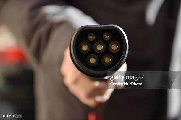 Man charging his electric car is seen in L'Aquila, Italy, on February 16, 2023. European Union confirmed the stop to new gasoline and gasol car sale...