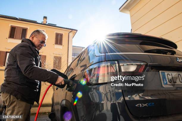 Man charging his electric car is seen in L'Aquila, Italy, on February 16, 2023. European Union confirmed the stop to new gasoline and gasol car sale...