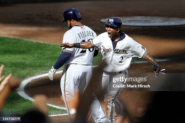 Nyjer Morgan of the Milwaukee Brewers celebrates after scoring the go ahead run on a single by Ryan Braun during the 7th inning of game action...