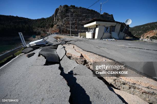 Picture taken on February 16, 2023 shows cracks on a road near the quakes epicenter, in Pazarcik district of the city of Kahramanmaras, after the...