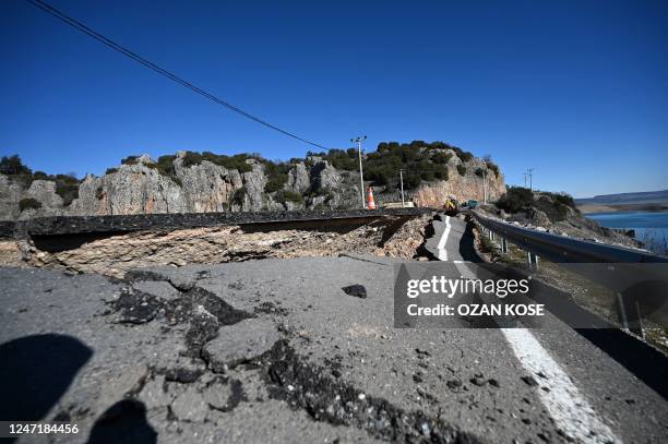 Picture taken on February 16, 2023 shows cracks on a road near the quakes epicenter, in Pazarcik district of the city of Kahramanmaras, after the...