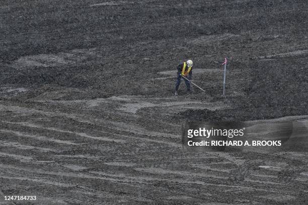 This photo taken on February 14, 2023 shows a worker at a soil separation facility where soil contaminated by the 2011 nuclear accident at the...