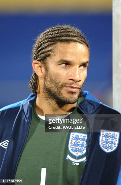 England's defender Rio Ferdinand sits on the substitute bench prior to the start of the the Group C first round 2010 World Cup football match England...