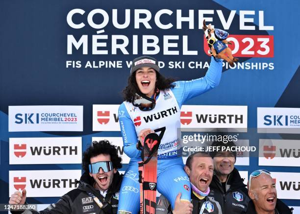 Second placed Italy's Federica Brignone celebrates with teammates on the podium for the Women's Giant Slalom event of the FIS Alpine Ski World...