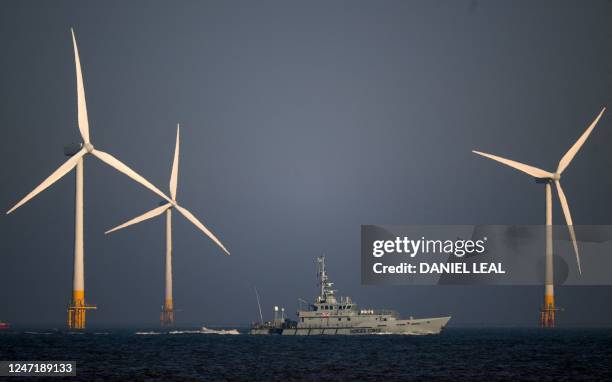 Border Force Cutter HMC Seeker passes wind turbines at RWE's Scroby Sands Wind Farm, off the coast of Great Yarmouth, eastern England, on February...